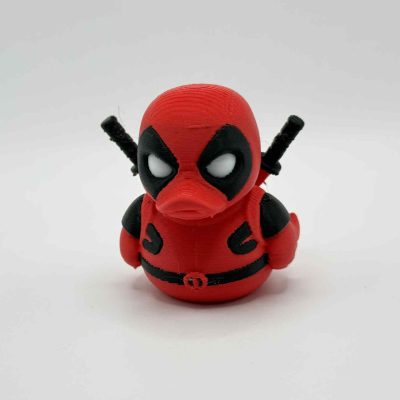 Red-and-black masked antihero-style collectible duck