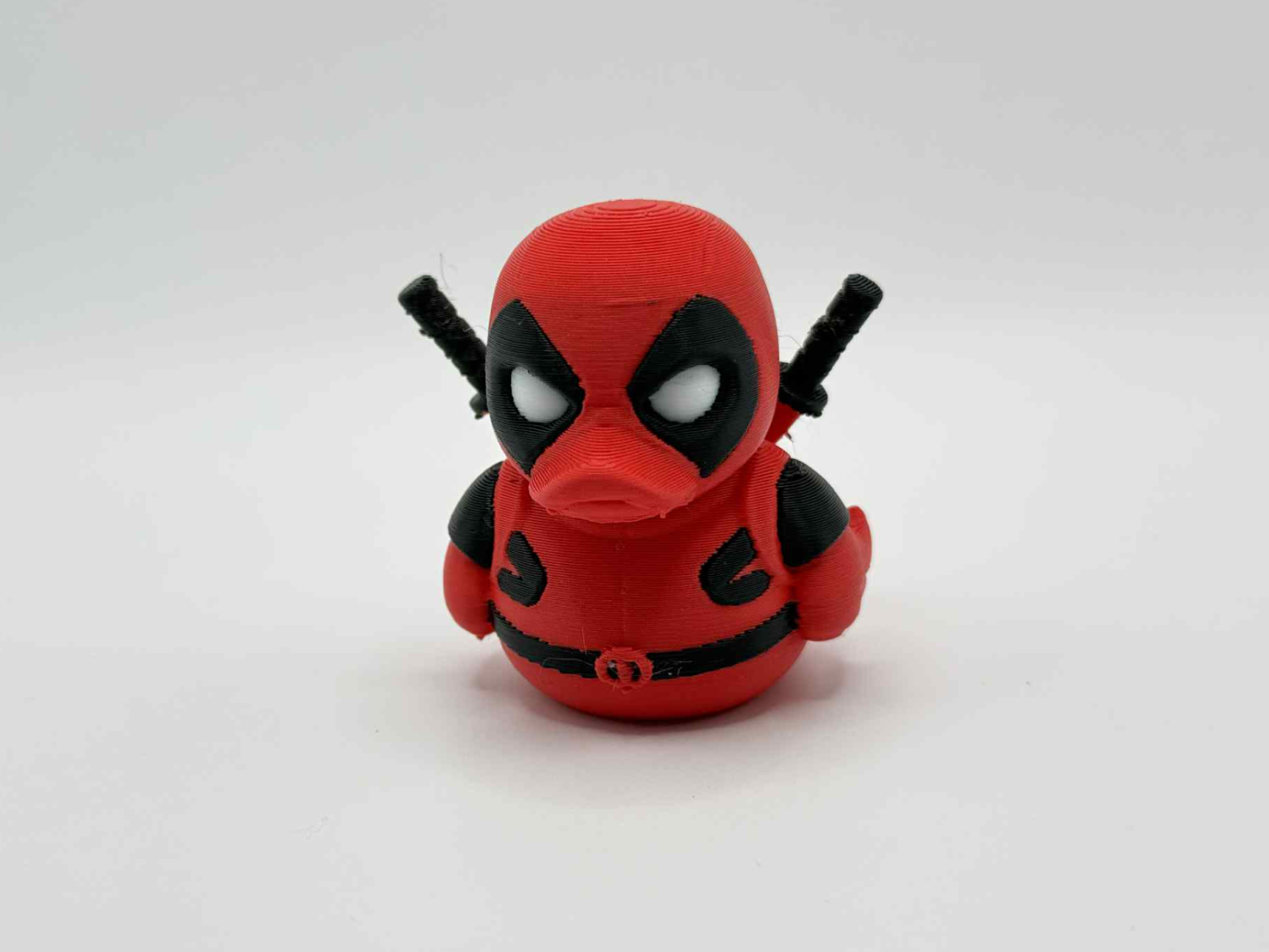 Red-and-black masked antihero-style collectible duck