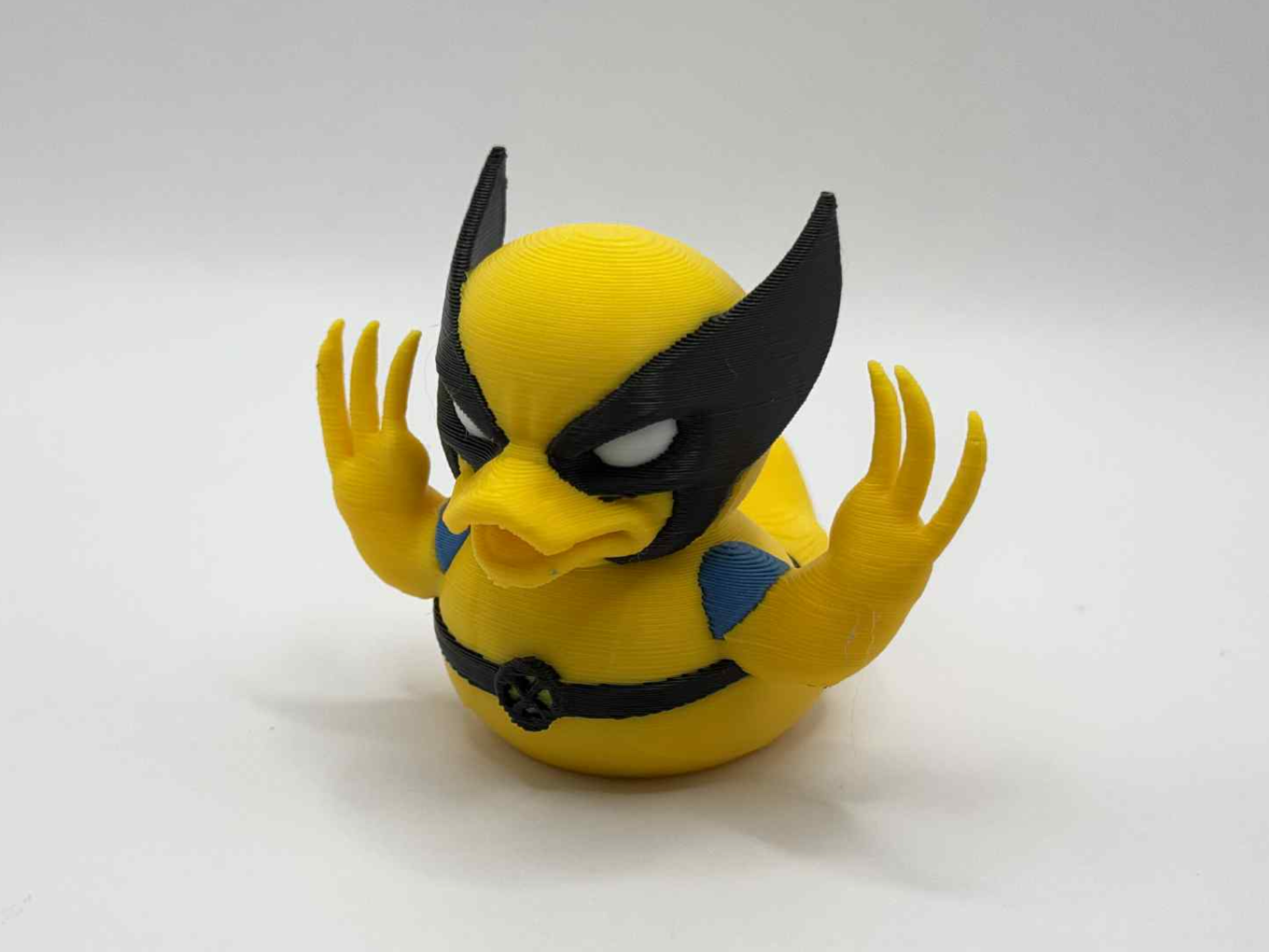 Yellow-and-blue clawed superhero-style collectible duck